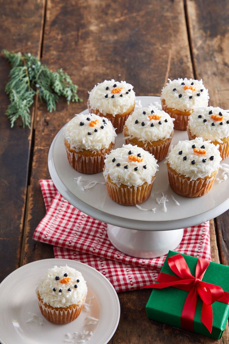 cupcakes decorated with frosting and sprinkles on a cake plate