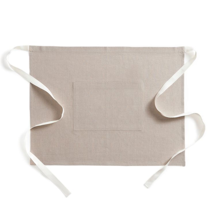 an apron with white straps is shown on a white background, and it has a square design in the middle