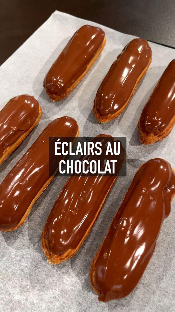 six chocolate covered donuts sitting on top of a piece of paper with the words eclairs au chocolat