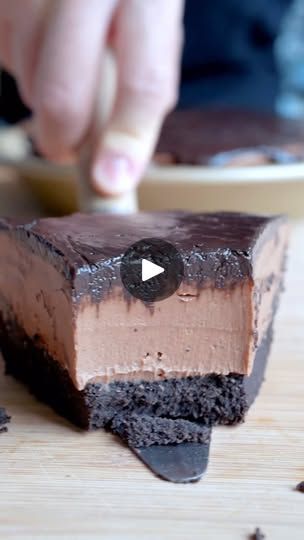 a piece of chocolate cake being cut with a knife