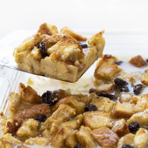 a close up of a spoonful of food in a dish with raisins