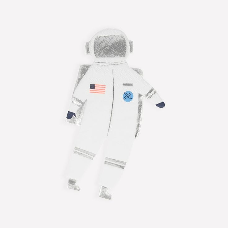 an astronaut doll is laying on the ground with its eyes closed and one hand in it's pocket