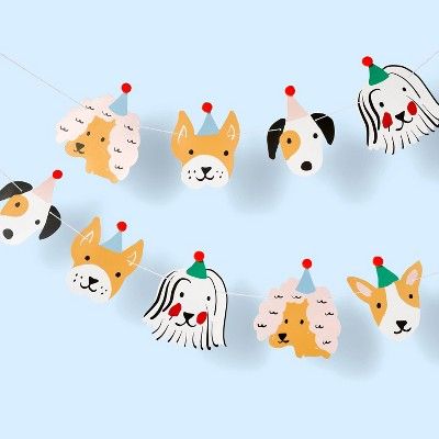 a dog party garland with dogs wearing hats on it's head, hanging from a string