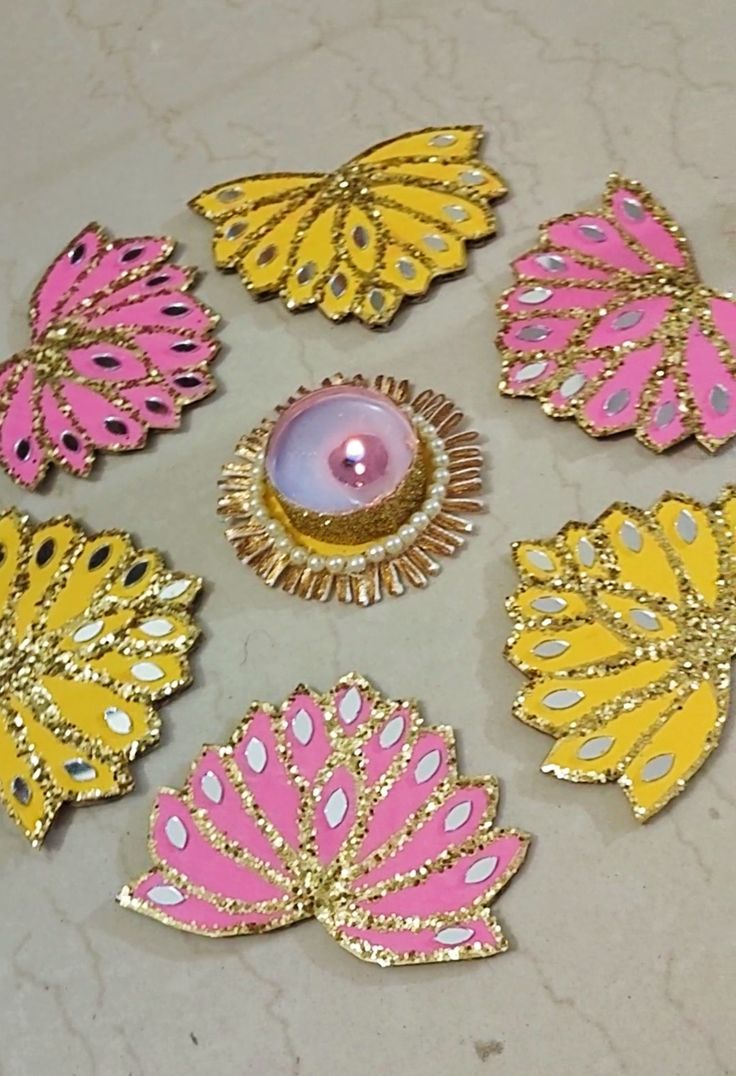 some pink and yellow flowers with a candle in the middle on a white counter top