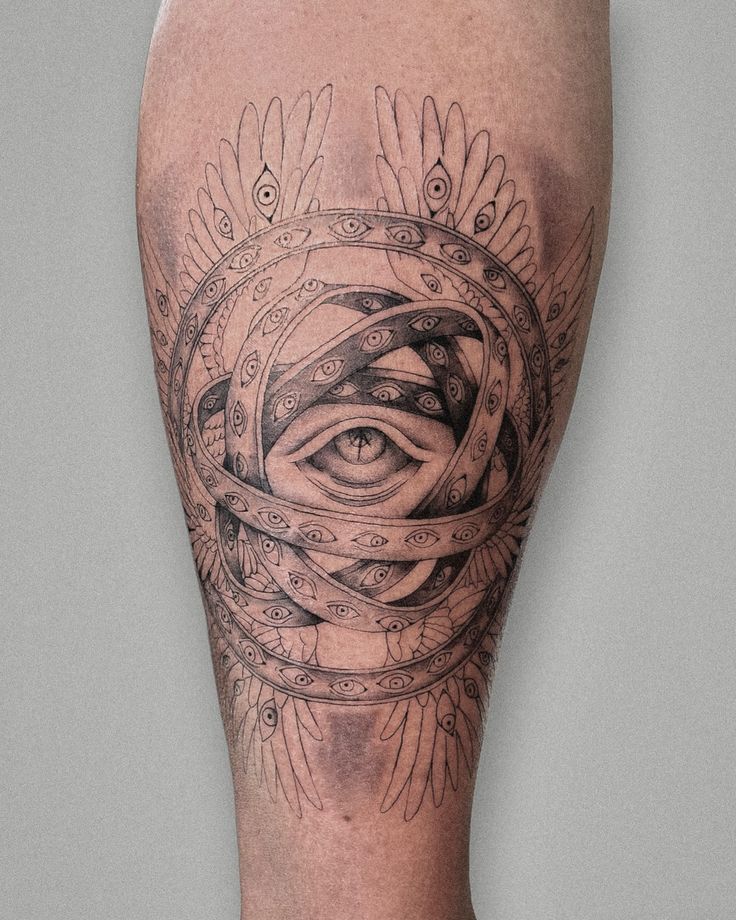 a man's leg with an all seeing tattoo on it