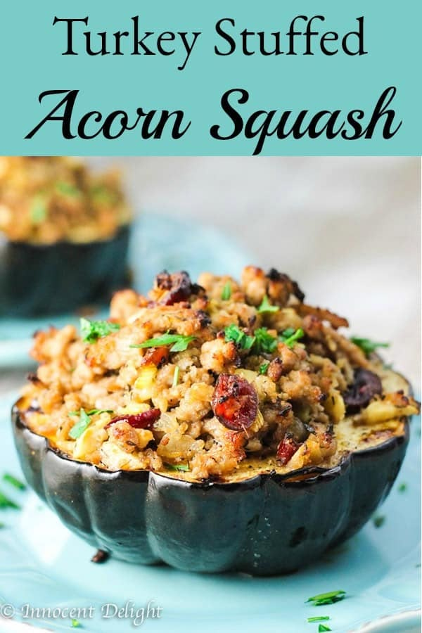 stuffed acorn squash on a blue plate with the words turkey stuffed acorn squash