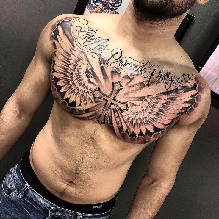 a man with a cross and wings tattoo on his chest