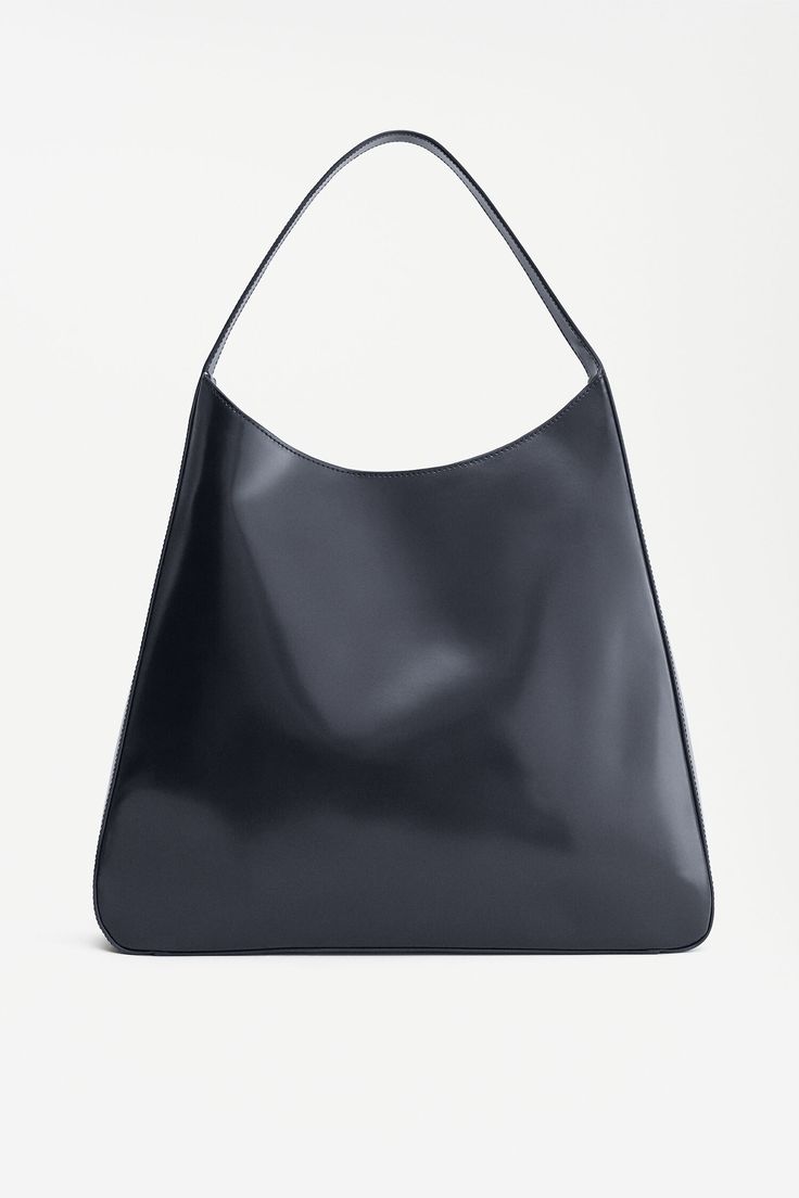 Sleek Soft Leather Tote Bag, Timeless Evening Bags With Leather Handles, Sleek Tote Bag With Top Carry Handle, Timeless Rectangular Hobo Bag With Removable Pouch, Timeless Black Bags With Leather Handles, Sleek Satchel Bag For Shopping, Sleek Rectangular Hobo Bag For Formal Occasions, Sleek Leather Bag With Double Handle, Timeless Black Shoulder Bag For Shopping