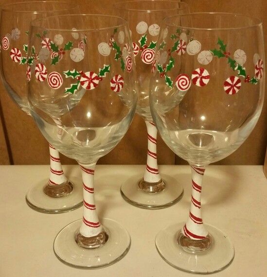 three wine glasses decorated with candy canes and candies are sitting on a counter