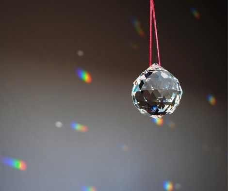 a crystal ball hanging from a red string