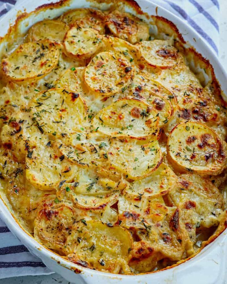 baked potato casserole in a white dish on a blue and white striped towel