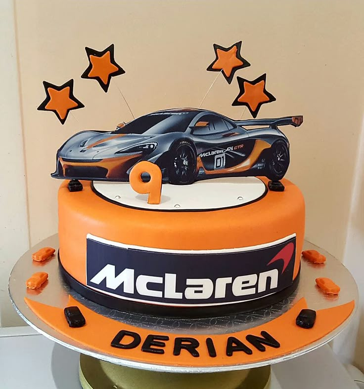 a birthday cake with a car on top and stars around the edges that say, mclaren derian