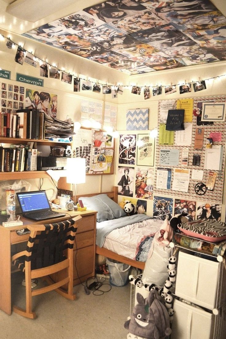 a dorm room with a bed, desk and bookshelf full of pictures on the wall