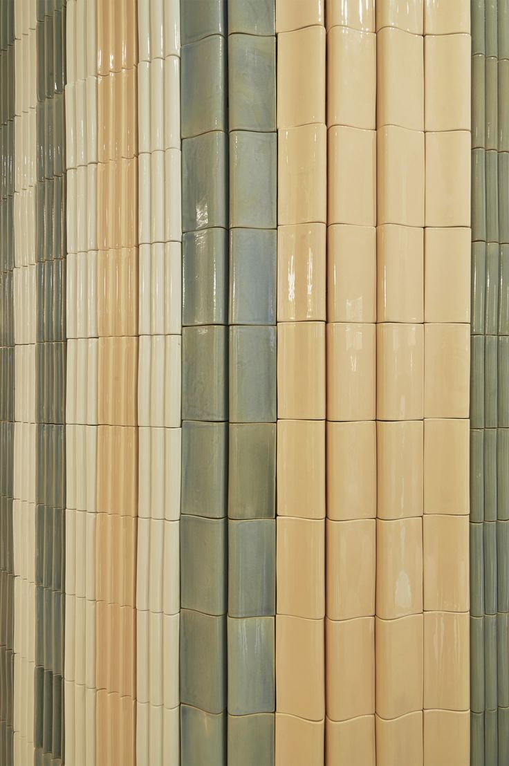 the wall is made up of different colored ceramic tiles and has vertical stripes on each side