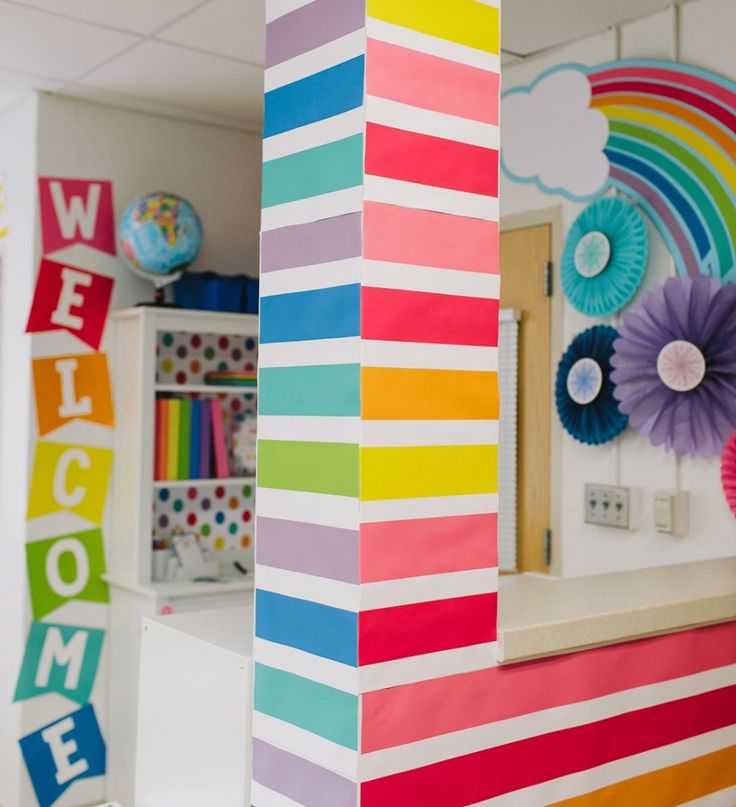 a colorful classroom decorated with paper flowers and rainbow decorations