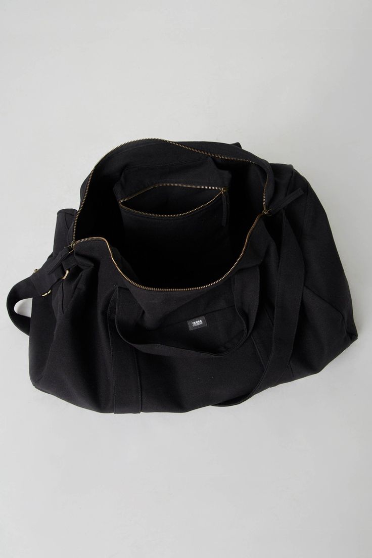 Nothing beats the simplicity and functionality of a good duffle bag—except maybe our Bumi Eco Duffel Bag, made with the good of the environment and people in mind! The perfect size for a spontaneous weekend getaway or when you need a little more room to haul daily gear for work or athletics.  Bag: 13"(H) x 20"(W) x 12"(D) Made with 12 to 14 oz Certified Fairtrade Organic cotton canvas Approximately 56L capacity Main compartment zippers with long pulls Internal zippered hanging pocket sized 9” (H Versatile Duffle Bag For Overnight Trips With Zipper Pocket, Cotton Weekender Bag For Overnight Trips, Cotton Duffle Bag With Large Capacity For Overnight Trips, Large Capacity Weekender Backpack Bag, Black Cotton Weekender Bag With Large Capacity, Large Capacity Backpack Weekender Bag, Large Capacity Weekender Backpack, Functional Cotton Bag For Overnight Trips, Functional Cotton Travel Bag For Overnight Trips