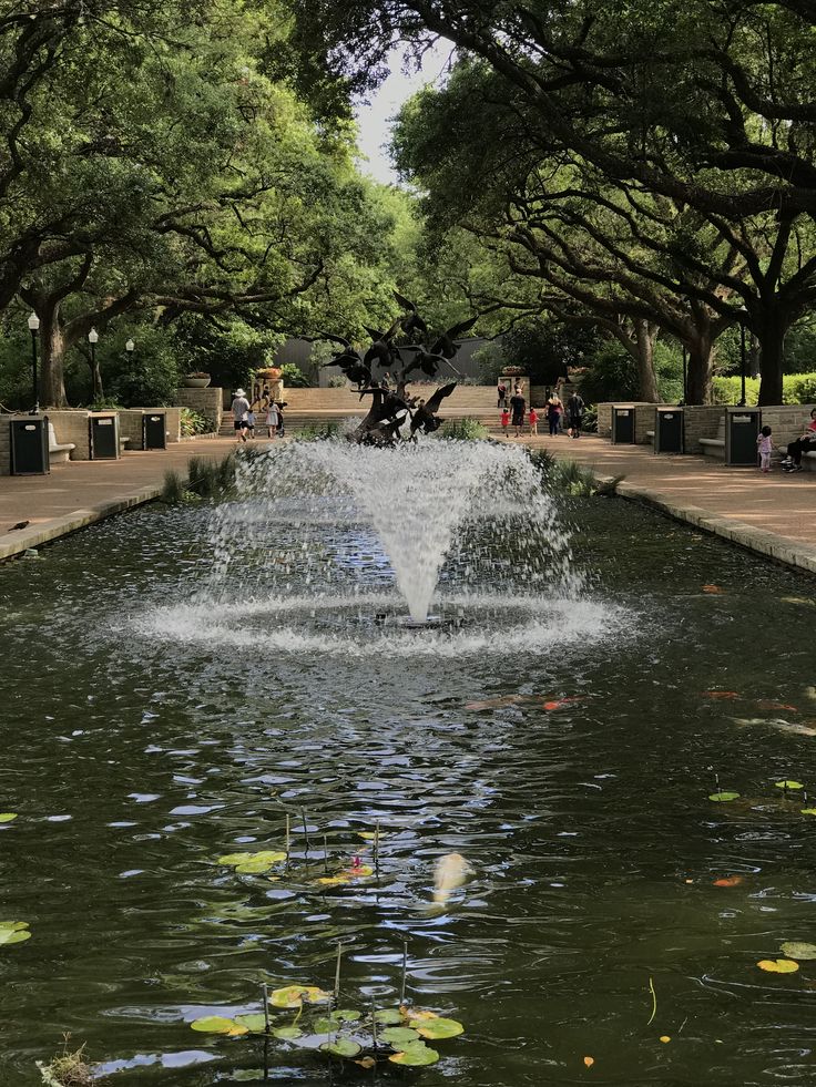 a water fountain in the middle of a park