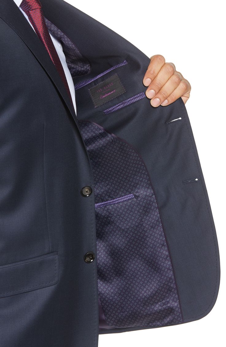 Finely textured wool and meticulous pickstitching define a modern-cut suit featuring flat-front trousers paired with a notch-lapel jacket. A tonal lining with purple thread stitching adds a pop of color to a sophisticated style. 29" length (size 42) Jacket has notched lapels; four-button cuffs; chest welt pocket; front flap pockets; interior pockets; side vents Trousers have zip fly with hook-and-bar closure; front slant pockets; back button-welt pockets Jacket is lined; trousers are lined to th Classic Tailored Purple Suits, Purple Notch Lapel Suit For Business, Tailored Purple Suit With Notch Lapel, Purple Tailored Suit With Notch Lapel, Tailored Purple Suit For Business, Tailored Purple Business Suit, Tailored Single-breasted Purple Suits, Single-breasted Purple Suit For Business, Tailored Purple Blazer For Business