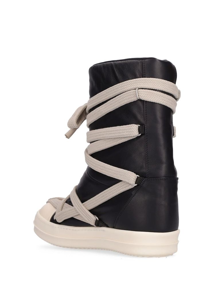 Rick Owens Puffer Mega Lace Boots Designer's ID: RU02B2895-LLPW1 The Rick Owens Puffer Mega Lace Boots, featured in the FW23 collection, present a sleek black leather upper accented by an integrated jumbo mega lacing system. This unique design is complemented by Rick's signature natural rubber shark teeth sole, perfectly encapsulating the avant-garde and bold aesthetic of the Rick Owens Shoes collection. Color: Black Composition: Leather Upper- Rubber Made in ITALY Rick Owens Puffer, Rick Owens Boots, Rick Owens Shoes, Punk Outfits, Swag Shoes, Baby Boots, Shark Teeth, Dream Shoes, Dark Fashion