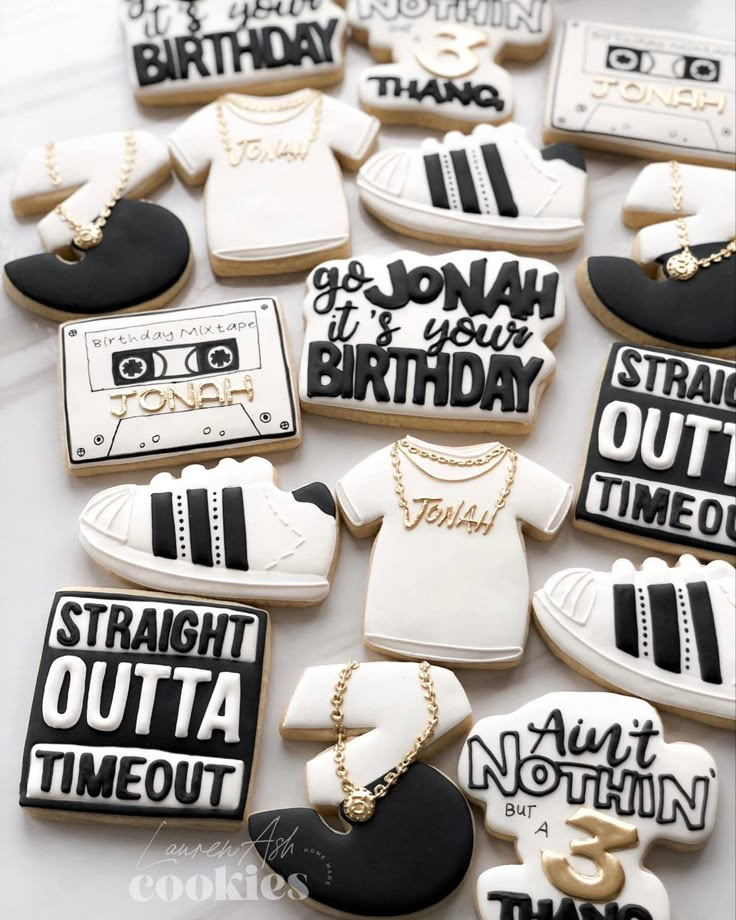 cookies decorated to look like tennis shoes, sneakers and t - shirts with words on them