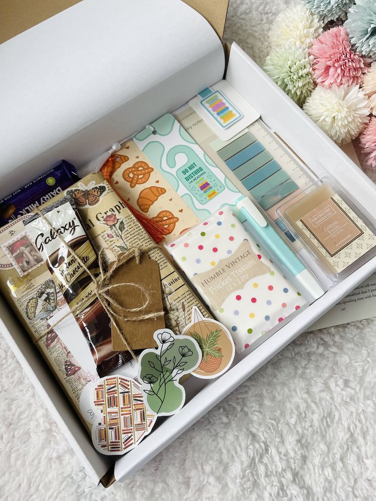 an open box filled with assorted items on top of a white carpeted floor