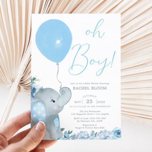 a person holding up a baby shower card with an elephant and blue balloon on it