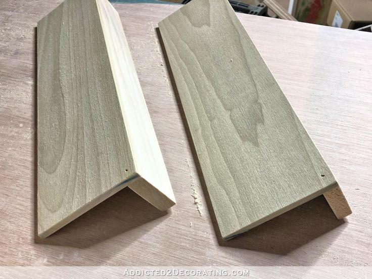 two pieces of wood sitting on top of a table