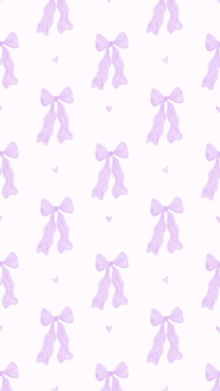 pink bows and hearts on a white wallpaper with pastel purple colors in the background