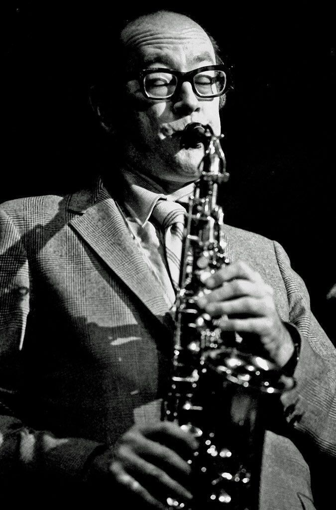 black and white photograph of a man playing a saxophone