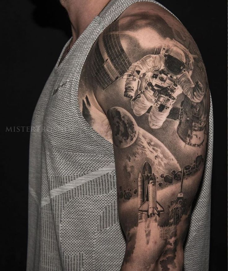 a man's arm with an astronaut tattoo on it