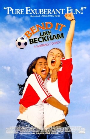 two young women are hugging in front of a soccer ball and the words bend it like beckham