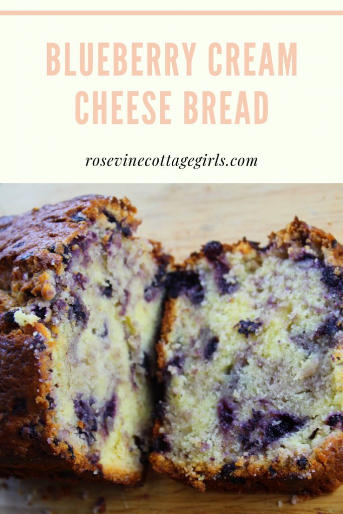 blueberry cream cheese bread cut in half on a cutting board with text overlay