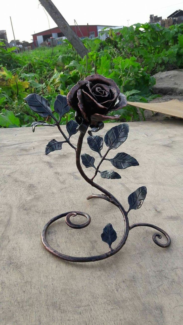 a wrought iron rose on the ground