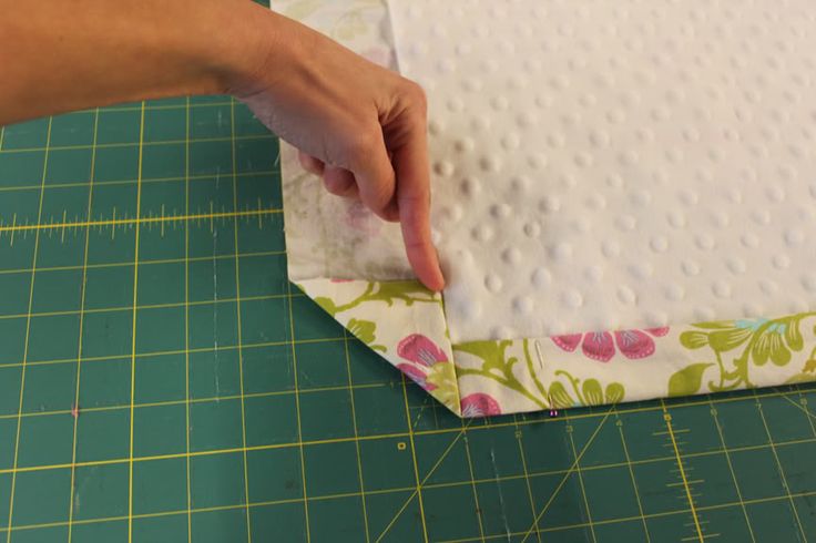 someone is cutting up fabric to make a pillow