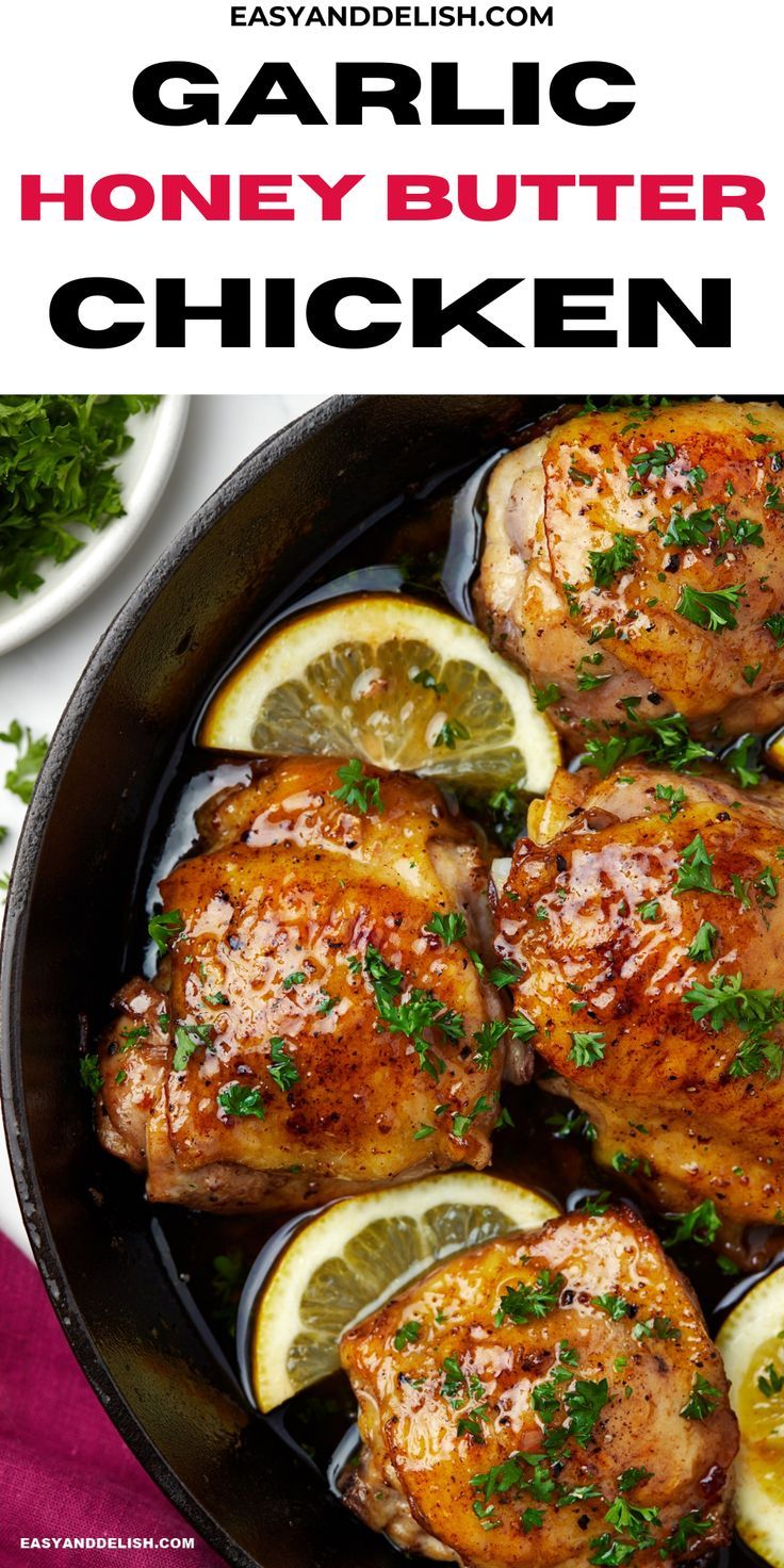 garlic honey butter chicken in a skillet with lemons and parsley