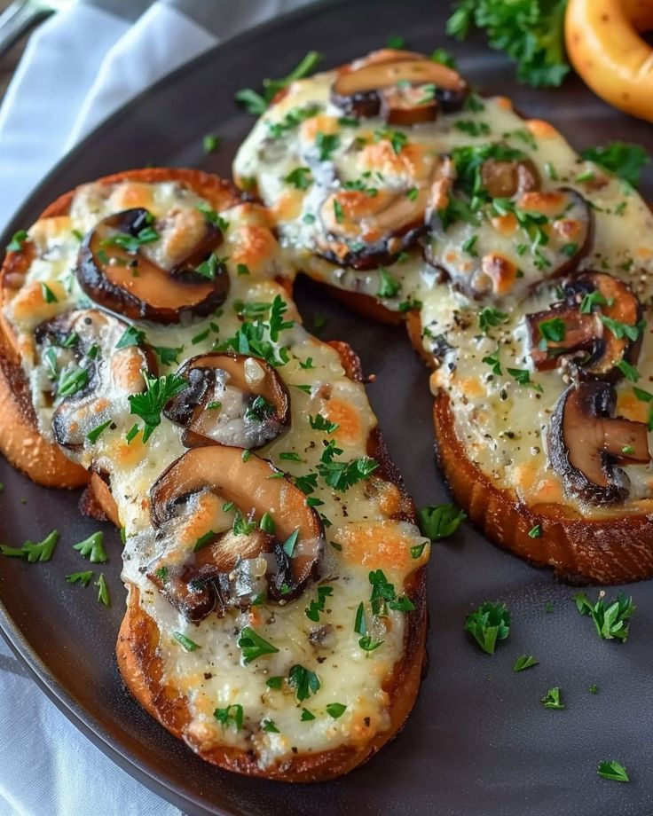 an assortment of food on a plate with cheese and mushrooms in the middle, along with pretzels