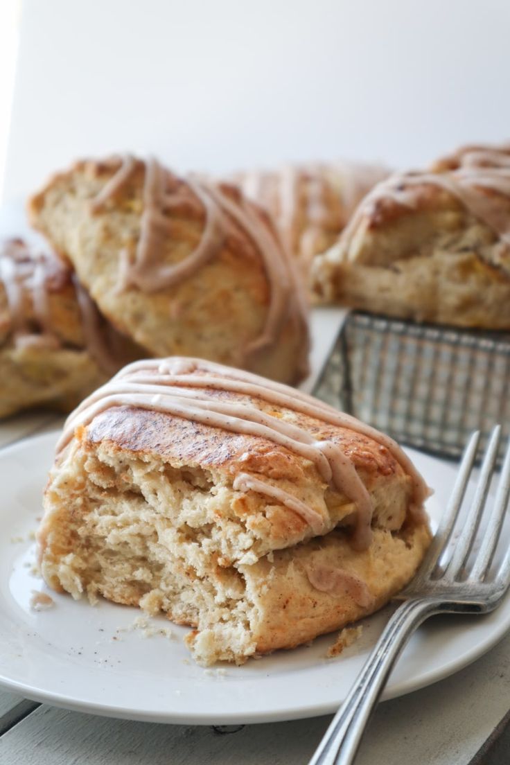 a white plate topped with scones covered in frosting