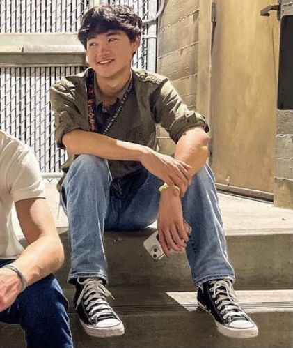 two young men sitting next to each other on steps