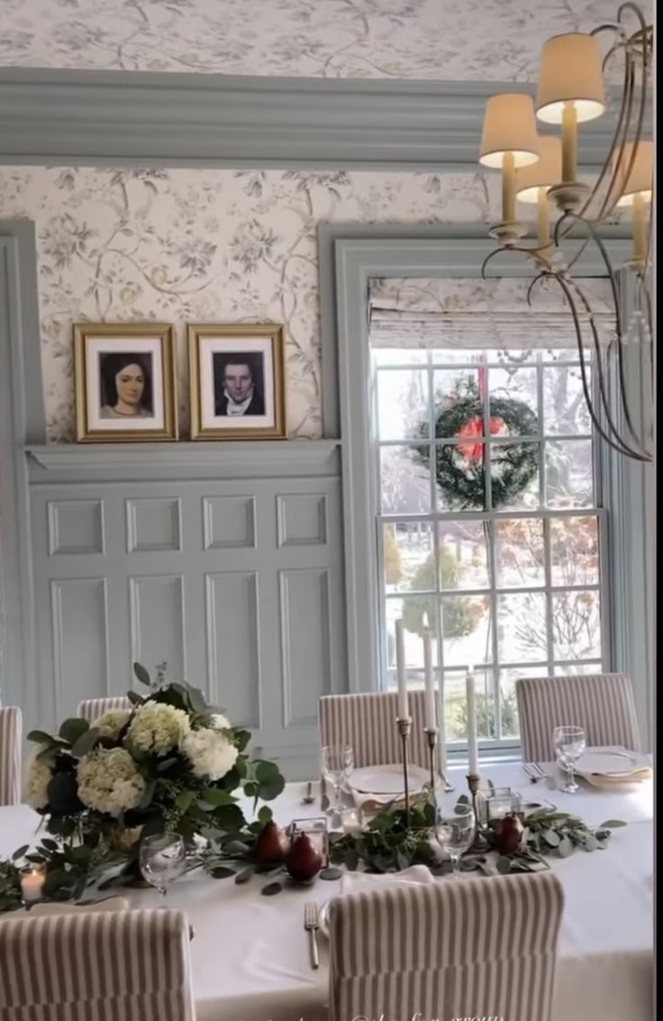 the table is set with flowers and greenery for an elegant christmas dinner or party