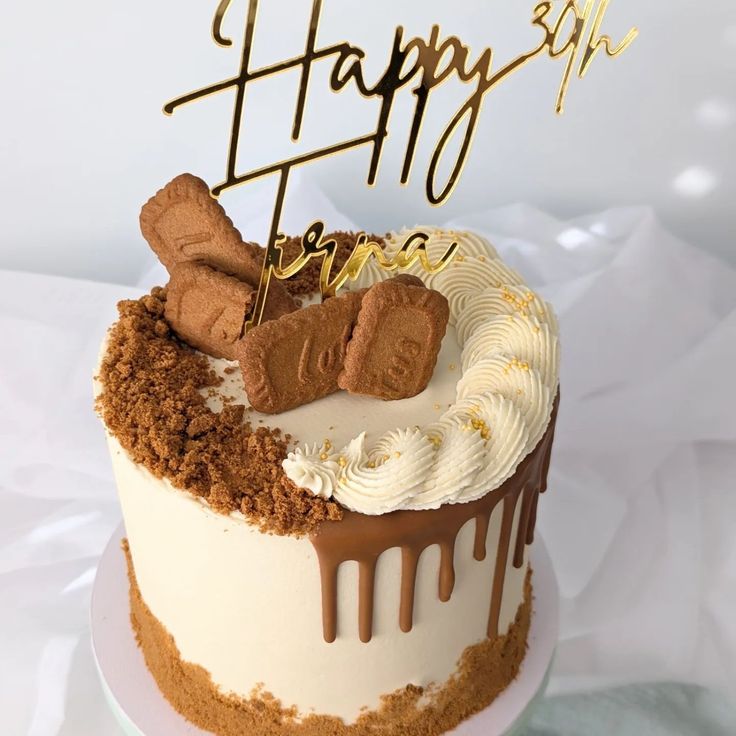 a birthday cake with white frosting and chocolate toppings