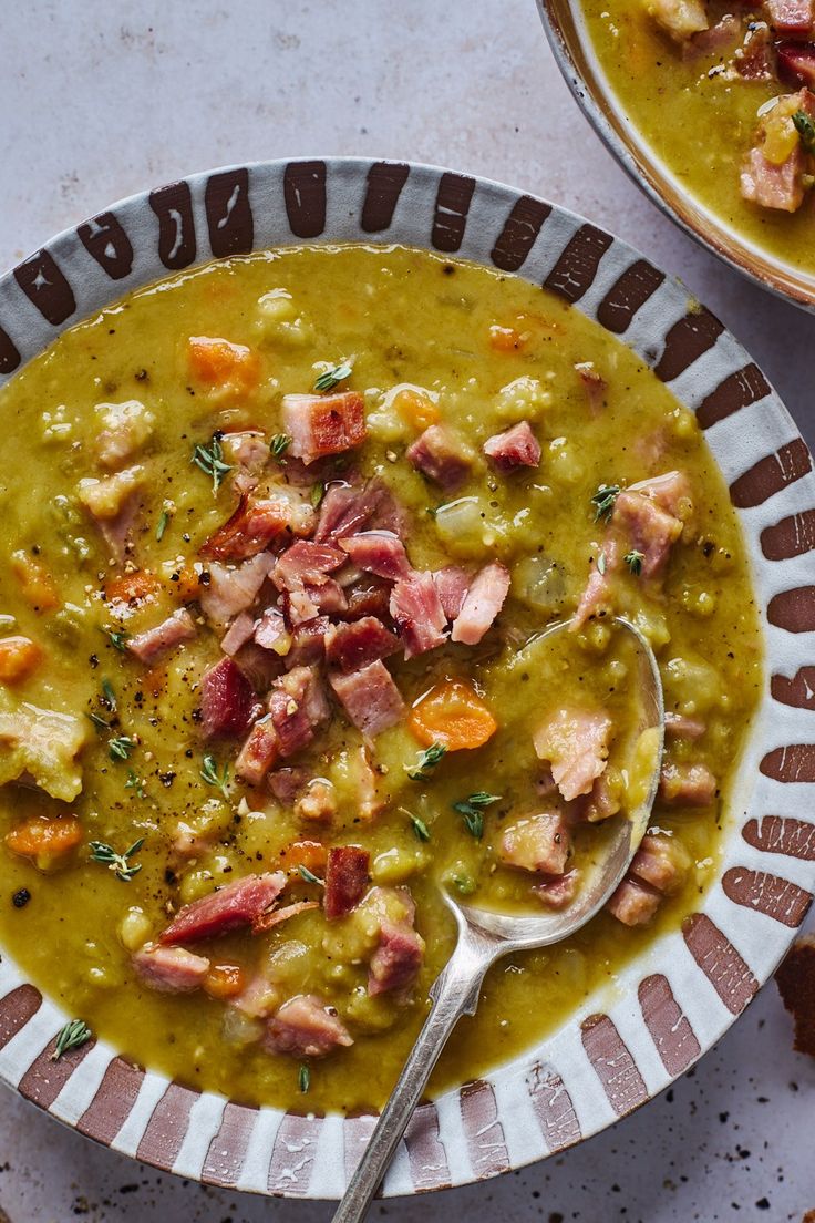 two bowls filled with soup on top of a table