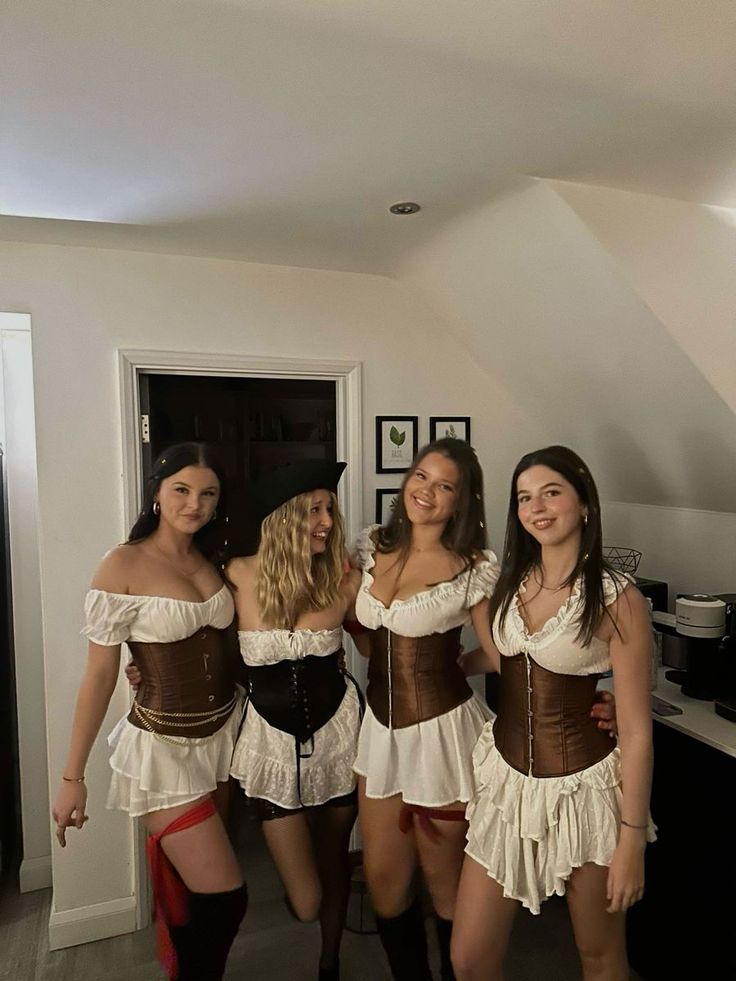 four women dressed in corsets posing for the camera