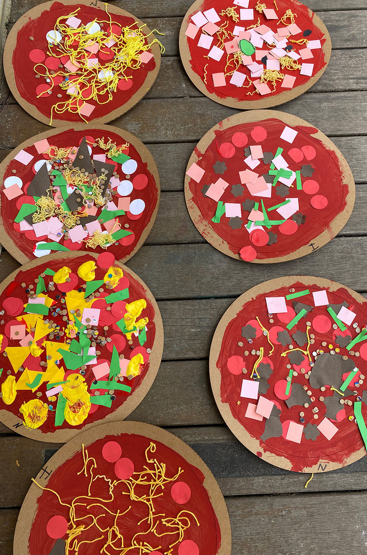 four paper plate pizzas with different designs on them