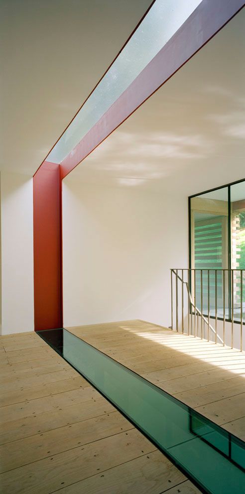 an empty room with wooden flooring and white walls