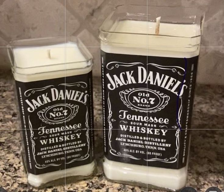 two candles sitting on top of a counter