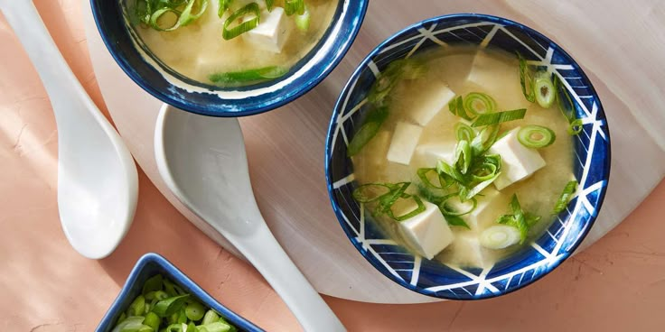 three bowls filled with soup on top of a table