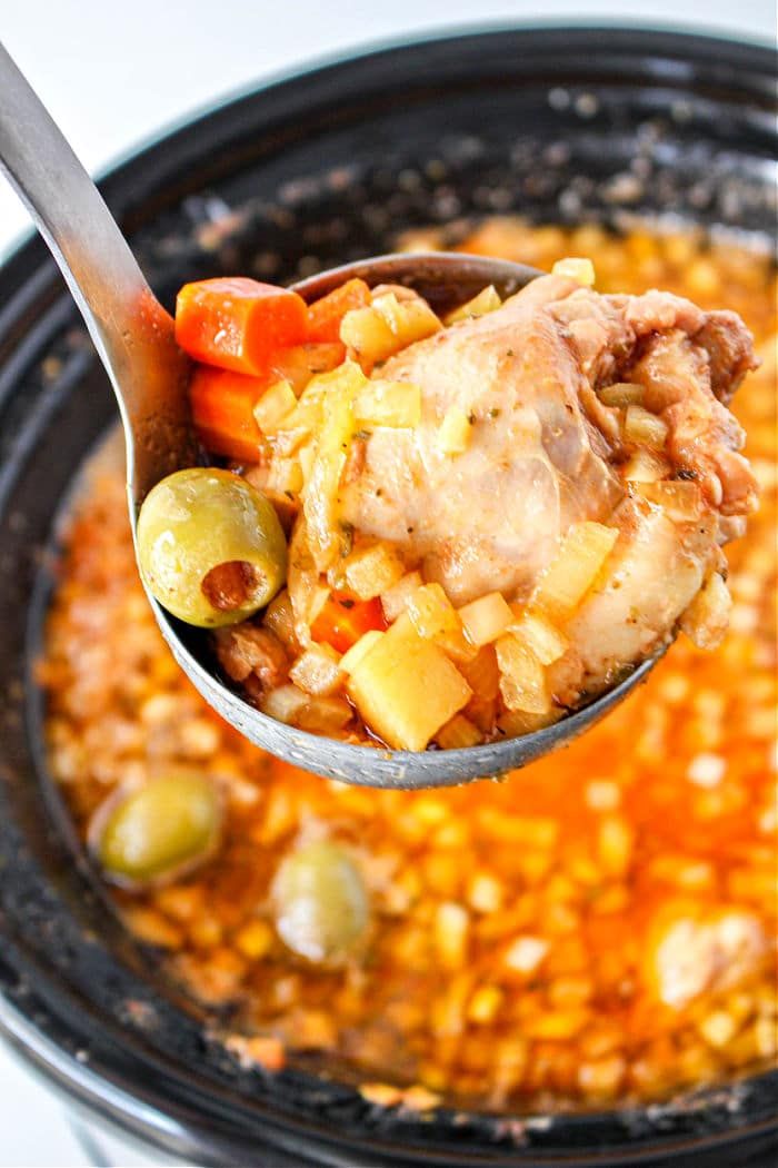 a spoon full of soup with meat and vegetables