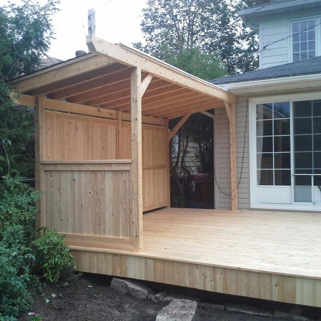 a wooden deck with a shed attached to it