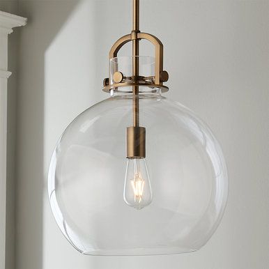 a light fixture hanging from the ceiling with a clear glass ball on it's side