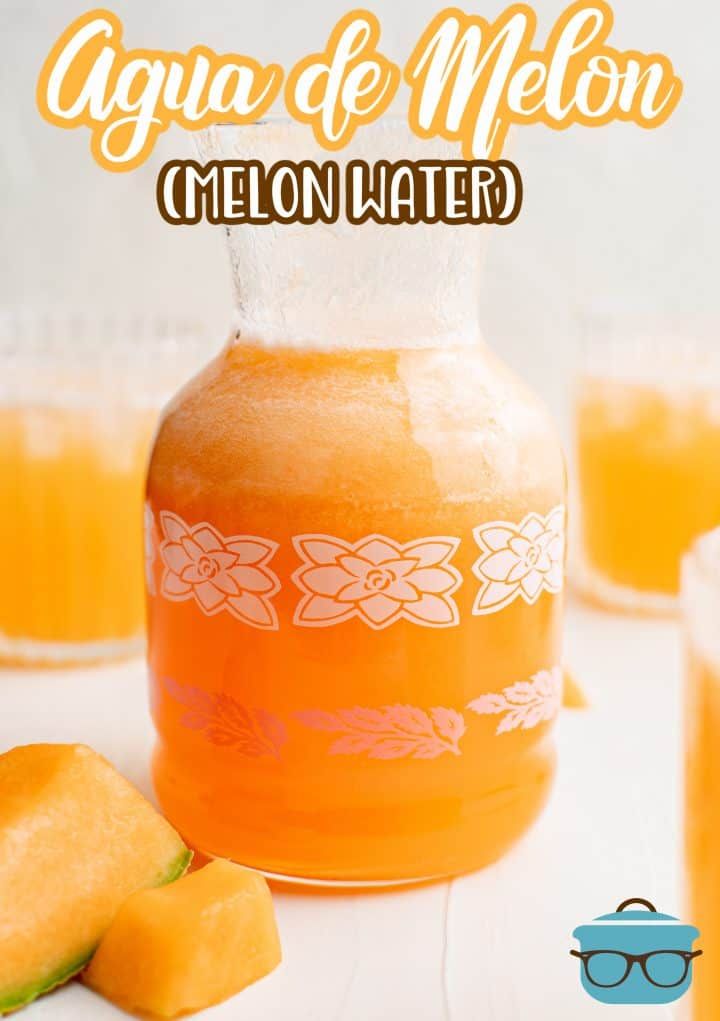 an orange liquid in a glass jar next to sliced melon